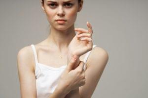 disgruntled woman arm pain arthritis chronic disease isolated background