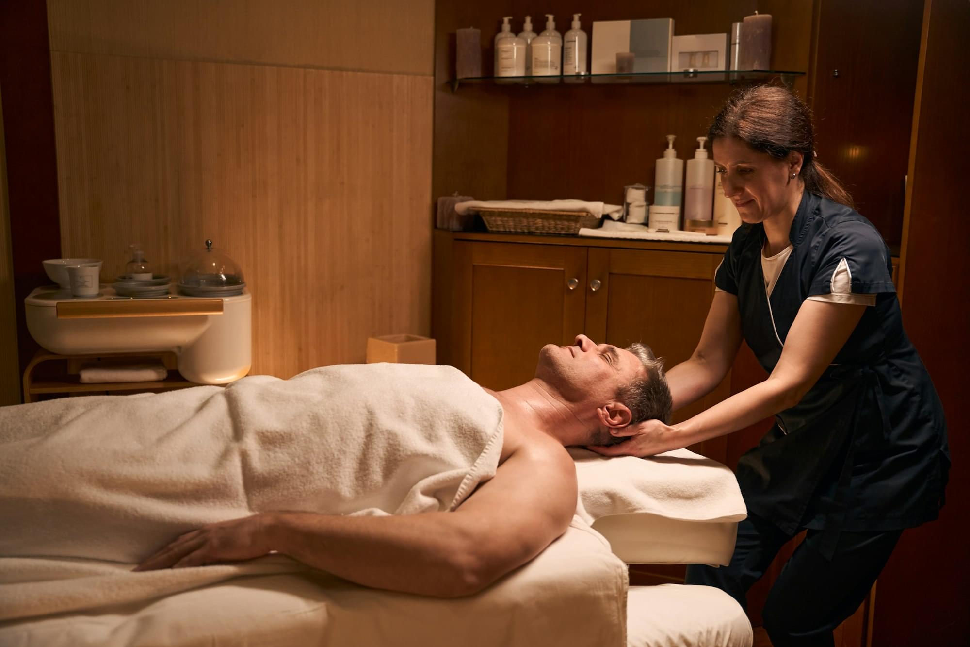 Experienced osteopath performing manipulation of cervical spine