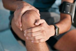 Man, knee pain and closeup for training outdoor, exercise and fitness for muscle development. Runne