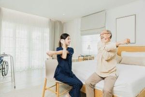 Nurse look after elderly patient exercising